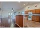 Bright kitchen with bar seating, hardwood floors, and vaulted ceilings, perfect for modern living at 1563 E Racine Dr, Casa Grande, AZ 85122