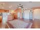 The open living room features wood-look floors, ceiling fan, and an arched doorway at 1563 E Racine Dr, Casa Grande, AZ 85122