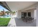 Covered patio provides a comfortable outdoor dining area overlooking the pool and backyard at 16008 N 60Th St, Scottsdale, AZ 85254