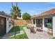 Private backyard features a lush lawn, paved patio, and charming outdoor seating area at 16008 N 60Th St, Scottsdale, AZ 85254