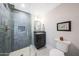 Stylish bathroom featuring glass shower, gray tile, black vanity, and modern fixtures at 16008 N 60Th St, Scottsdale, AZ 85254