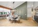 Bright dining room features a modern light fixture and elegant olive green accent wall at 16008 N 60Th St, Scottsdale, AZ 85254