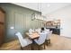 This dining area features a wooden table with a view of a modern bar at 16008 N 60Th St, Scottsdale, AZ 85254