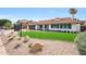 Charming home with well-maintained landscaping, decorative rock, and a manicured lawn at 16008 N 60Th St, Scottsdale, AZ 85254