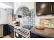 Close-up of kitchen stove, featuring a designer backsplash at 16008 N 60Th St, Scottsdale, AZ 85254