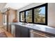 Modern kitchen with stainless steel appliances, sleek countertops, and a window view at 16008 N 60Th St, Scottsdale, AZ 85254