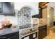 Gourmet kitchen featuring stove, custom backsplash, and modern appliances at 16008 N 60Th St, Scottsdale, AZ 85254
