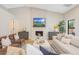 Cozy living room with fireplace, TV, and comfortable seating arrangement at 16008 N 60Th St, Scottsdale, AZ 85254