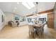 Bright, open-concept living and dining area features hardwood floors, fireplace, skylight, and wooden beam at 16008 N 60Th St, Scottsdale, AZ 85254