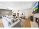 Spacious living area with hardwood floors, a fireplace, a skylight, and modern decor at 16008 N 60Th St, Scottsdale, AZ 85254