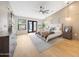 Light filled bedroom with wood floors and a ceiling fan at 16008 N 60Th St, Scottsdale, AZ 85254