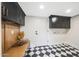 Mud room boasts checkered floors and sleek, dark cabinetry with contrasting hardware at 16008 N 60Th St, Scottsdale, AZ 85254