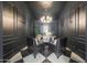 Elegant home office featuring black walls, decorative lighting, and a modern desk with chairs at 16008 N 60Th St, Scottsdale, AZ 85254