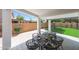 Spacious covered patio perfect for outdoor entertaining with a table and view of the yard at 16008 N 60Th St, Scottsdale, AZ 85254
