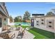 Backyard features a pristine pool, a pool house/teen room, and patio seating for lounging by the pool at 16008 N 60Th St, Scottsdale, AZ 85254