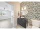 Elegant powder room showcasing designer wallpaper, vessel sink, and black vanity at 16008 N 60Th St, Scottsdale, AZ 85254