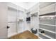 Walk-in closet featuring custom shelving and wooden floors at 16008 N 60Th St, Scottsdale, AZ 85254