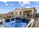 Backyard view showcasing a luxurious hot tub and covered patio area at 1601 S 215Th Dr, Buckeye, AZ 85326