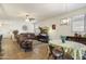 Inviting living room with dining area, comfortable seating, and a cozy fireplace at 1601 S 215Th Dr, Buckeye, AZ 85326