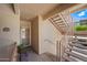 Exterior view of a unit entrance, including stairs, a front door with a storm door, and potted plants at 16631 E El Lago Blvd # 212, Fountain Hills, AZ 85268