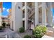 Exterior apartment architecture featuring stairs and a sidewalk with beautiful landscaping at 16631 E El Lago Blvd # 212, Fountain Hills, AZ 85268