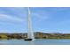 Beautiful lake fountain surrounded by community homes on a sunny day at 16631 E El Lago Blvd # 212, Fountain Hills, AZ 85268