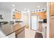 Well-lit kitchen with stainless steel sink, light wood cabinetry, and modern appliances at 16631 E El Lago Blvd # 212, Fountain Hills, AZ 85268