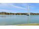 Serene lake view featuring a water fountain surrounded by landscaping on a sunny day at 16631 E El Lago Blvd # 212, Fountain Hills, AZ 85268