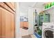 Laundry room features a washer and dryer, storage shelves, and cleaning supplies at 16631 E El Lago Blvd # 212, Fountain Hills, AZ 85268