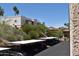 View of condo complex with carport parking, manicured desert landscaping, and desert mountain views at 16631 E El Lago Blvd # 212, Fountain Hills, AZ 85268