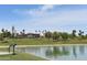 Community view of the pond with palm trees and nearby building at 16631 E El Lago Blvd # 212, Fountain Hills, AZ 85268