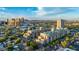 Condominium in urban neighborhood with lush trees, city views, blue skies, and mountain views at 17 W Vernon Ave # 412, Phoenix, AZ 85003