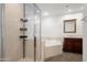 Bathroom featuring a glass shower, soaking tub, and vanity with a marble countertop at 17 W Vernon Ave # 412, Phoenix, AZ 85003