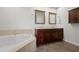 Bathroom featuring a soaking tub and a double sink vanity with granite countertops at 17 W Vernon Ave # 412, Phoenix, AZ 85003