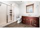 Well-lit bathroom with marble countertop, a cherry wood vanity, and a glass-enclosed shower at 17 W Vernon Ave # 412, Phoenix, AZ 85003