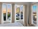 Bright bedroom boasts big windows with city views, neutral decor, and access to a private balcony at 17 W Vernon Ave # 412, Phoenix, AZ 85003
