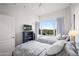 Inviting bedroom featuring two beds, a ceiling fan, and a large window with scenic views at 17 W Vernon Ave # 412, Phoenix, AZ 85003