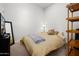 Neutral bedroom with comfortable bed, lamp, and built in shelving at 17 W Vernon Ave # 412, Phoenix, AZ 85003
