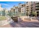 Complex exterior with multiple stories, a courtyard, brick accents, and landscaped areas at 17 W Vernon Ave # 412, Phoenix, AZ 85003