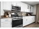 Modern kitchen featuring stainless steel appliances, white cabinetry, and granite countertops at 17 W Vernon Ave # 412, Phoenix, AZ 85003