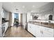 Open kitchen showcasing white cabinets, stainless steel appliances, and breakfast bar at 17 W Vernon Ave # 412, Phoenix, AZ 85003