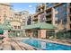 Community pool surrounded by lounge chairs and lush landscaping for relaxing outdoor enjoyment at 17 W Vernon Ave # 412, Phoenix, AZ 85003