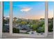 Nice window view of rooftops, mature trees, and city buildings at sunset at 17 W Vernon Ave # 412, Phoenix, AZ 85003