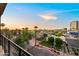 Nice view from an upper level with palm trees, neighborhood roofs, and a city skyline at sunset at 17 W Vernon Ave # 412, Phoenix, AZ 85003