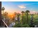 Charming neighborhood view at sunset from a high floor with tall palm trees in the foreground at 17 W Vernon Ave # 412, Phoenix, AZ 85003