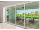 Sliding glass doors lead to a backyard patio with outdoor seating and lush landscaping at 1704 E Melrose St, Mesa, AZ 85203