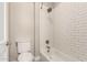 White subway tile surround the bathtub and shower fixtures in this bathroom at 1704 E Melrose St, Mesa, AZ 85203