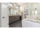 Beautiful bathroom with dual sinks, a walk-in shower, and a separate soaking tub for relaxation at 1704 E Melrose St, Mesa, AZ 85203