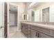 Bright bathroom featuring a double vanity with light grey cabinetry and modern fixtures at 1704 E Melrose St, Mesa, AZ 85203