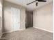 Cozy bedroom boasts neutral walls, carpet flooring, and two entry doors at 1704 E Melrose St, Mesa, AZ 85203